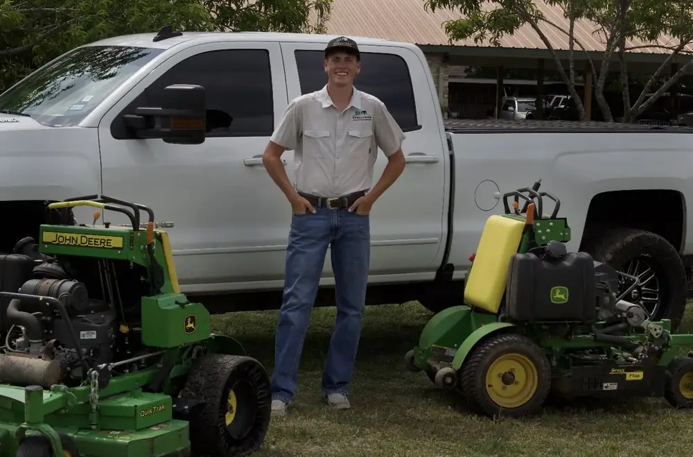 Levi Spellings with his truck and mowers