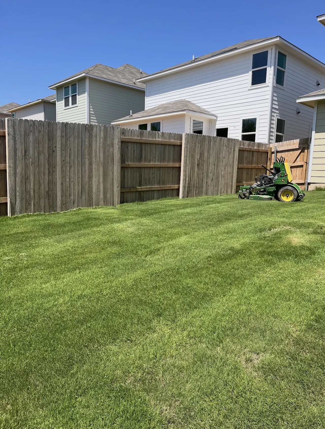 Mowing a backyard on a stand-on mower